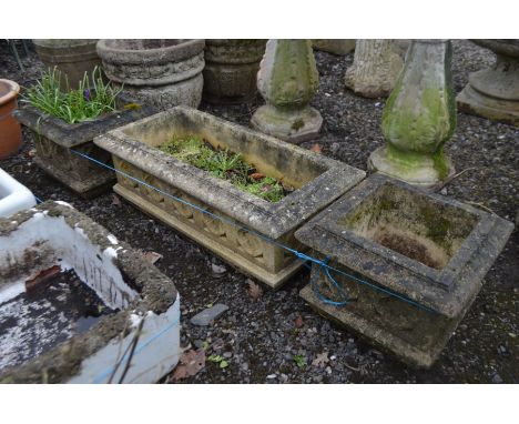 A SET OF THREE COMPOSITE GARDEN PLANTERS, comprising of a rectangular planter, length 70cm x depth 34cm x height 24cm and a p