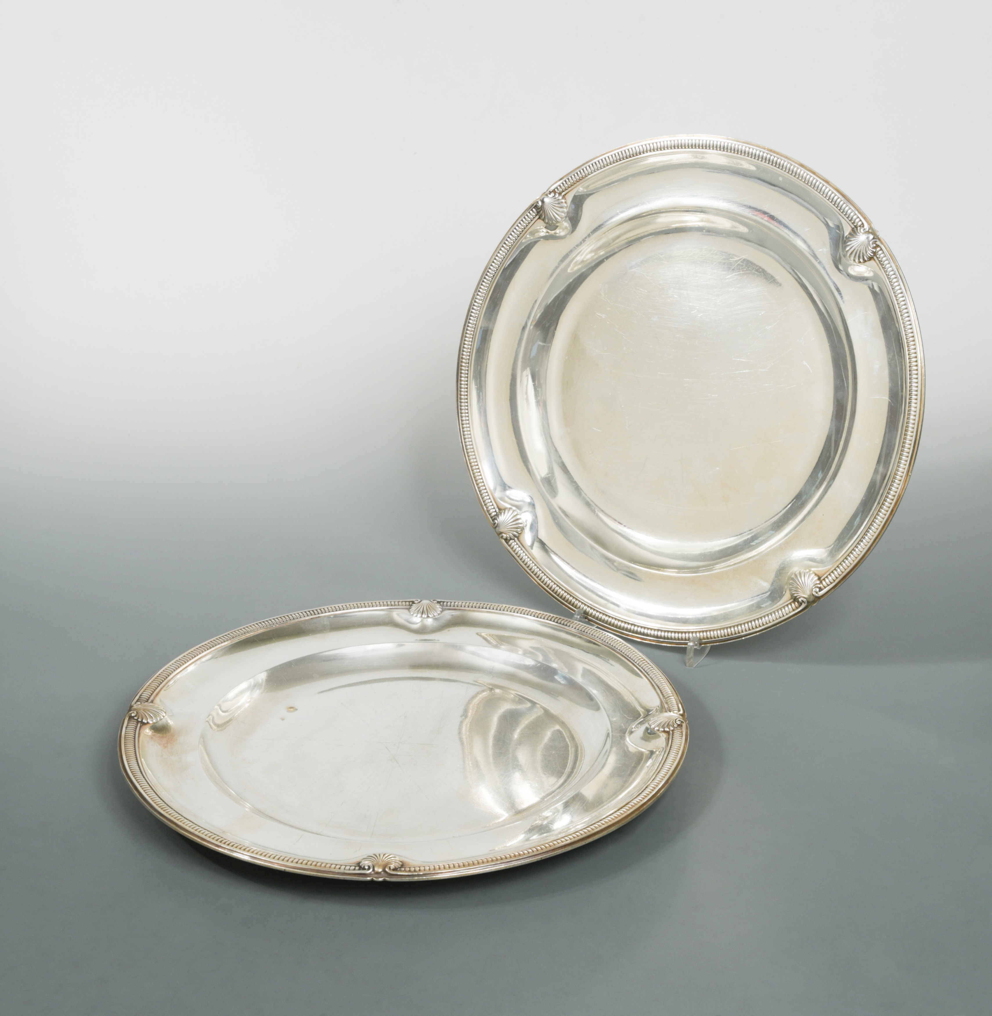 A pair of 20th century French metalwares silver platters, in Cheffins