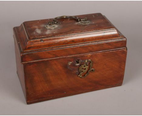 A Regency mahogany tea caddy. With brass swing handle to hinged lid and brass escutcheon.  