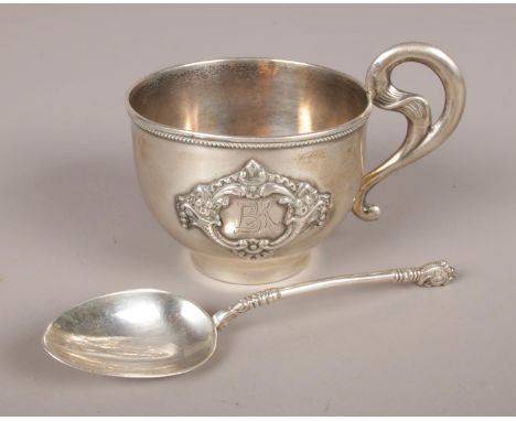 Two pieces of silver. A Russian silver vodka cup with beaded rim and scrolling handle. Applied carouche inscribed BR, stamped