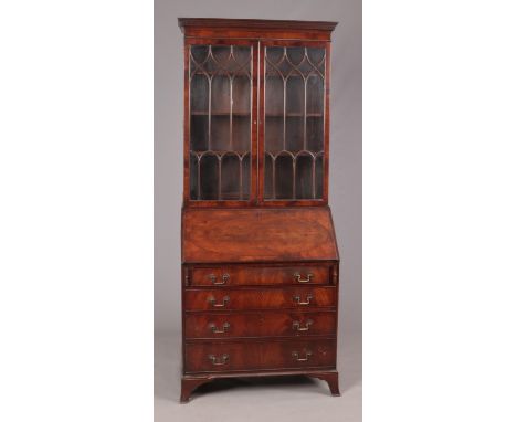 A late Georgian style figured mahogany astragal glazed bureau bookcase with shaped and fitted interior, raised on splay brack