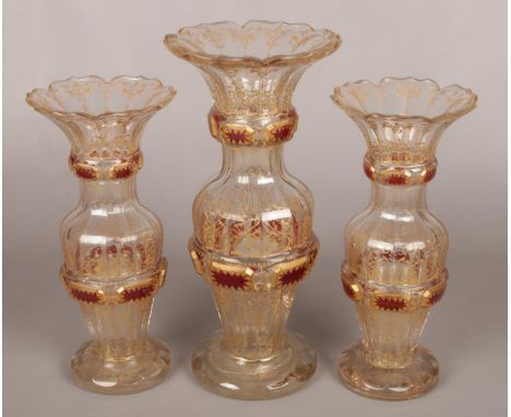 A garniture of early Bohemian clear glass vases. With gilt and cranberry flash decoration. Tallest 33.5cm  Largest vase with 