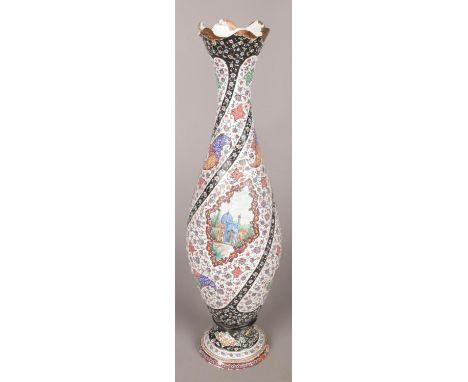 A Persian/Iranian enamelled copper vase. With painted landscape panels. Height 35cm.  Enamel loss and knocks.