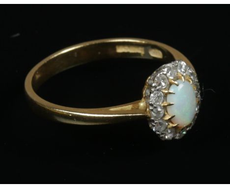 An 18ct gold opal and diamond ring. Size P. 3.19g.  