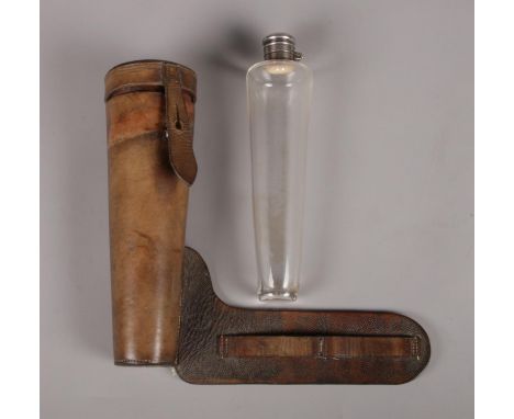 A leather cased glass hunting saddle flask with a Champion &amp; Wilton of Oxford Street, London plated flask top. H: 21cm.  