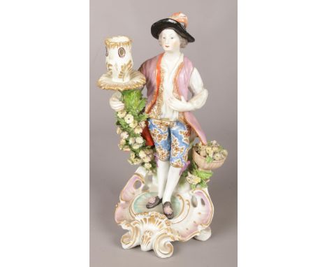 An 18th century Derby porcelain figural candlestick modelled as a gentleman with flower basket. 25cm.  Restoration to top of 