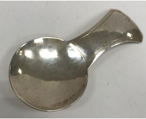 An Elizabeth II Arts &amp; Crafts style silver caddy spoon with hammered decoration (by William Henry (Harry) Warmington, Lon