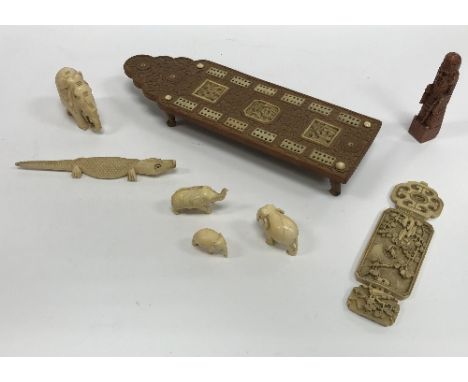 A box of various Oriental artefacts to include Cantonese foliate carved sandalwood and bone inlaid cribbage board, various el