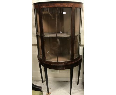 A 19th Century rosewood veneered display cabinet of demilune form, the glazed and barred door flanked by two similar glazed a