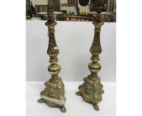 A pair of brass table lamps in the Baroque style, 50 cm high excluding light fittings and "A Standard Dictionary of the Engli