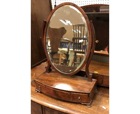 A 19th Century mahogany oval toilet mirror on a three-drawer satinwood strung bow-fronted base to ogee bracket feet (43.5 cm 