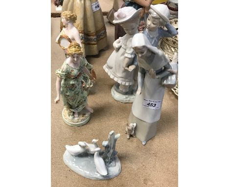 A Lladro figure of a woman with basket of bread and puppy at her feet, 27 cm high and a further figure group of a boy and gir