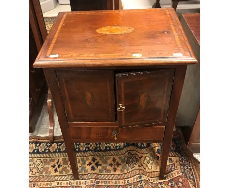 A 19th Century mahogany and inlaid pot cupboard, the top with moulded edge over two shell marquetry medallion inlaid doors an