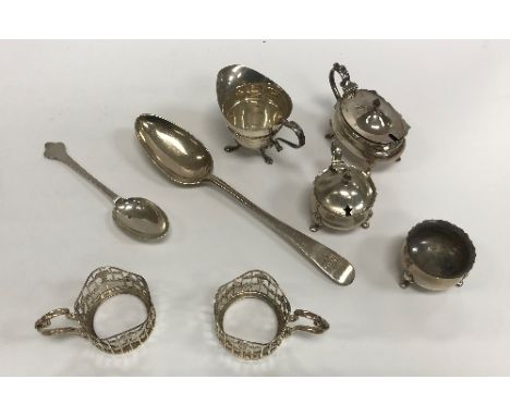 A collection of small silver wares to include four silver cup mounts, cream jug of helmet form, three piece cruet and twelve 