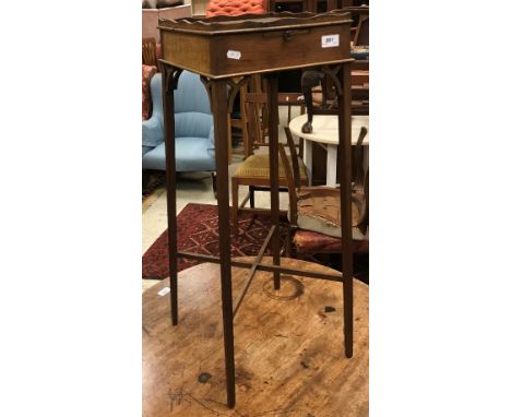 An Edwardian mahogany and inlaid plant stand in the Georgian style with galleried top over a brushing slide on slender square