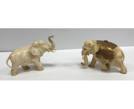 A 19th Century Japanese Meiji period carved figure of a bull elephant, signed to foot, 12 cm long x 8.4 cm high, together wit