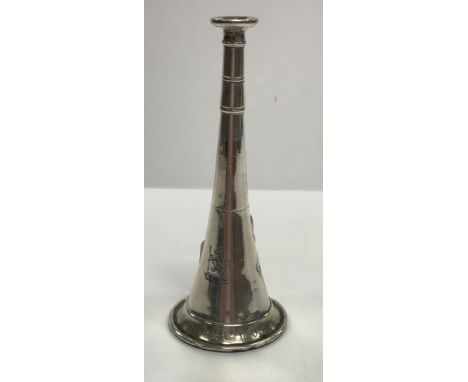 A Victorian silver novelty pepper as a hunting horn, bearing lion and arrow on a crown armorial and inscribed "CAE from RMC 1