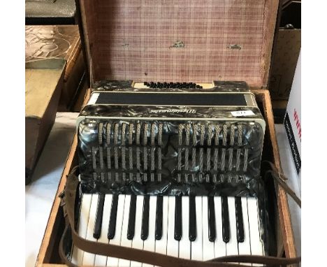 A Worldmeister simulated mother of pearl veneered accordion in case
