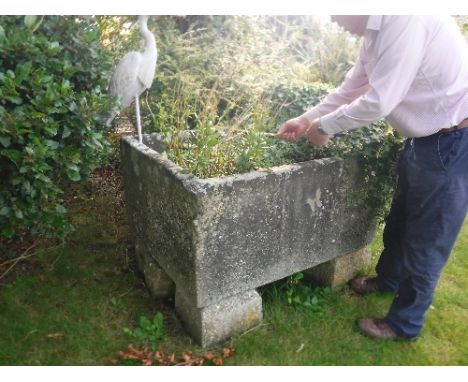 A large natural stone rectangular trough raised on four block bases, trough measurement 115 cm x 92 cm x 57 cm high CONDITION