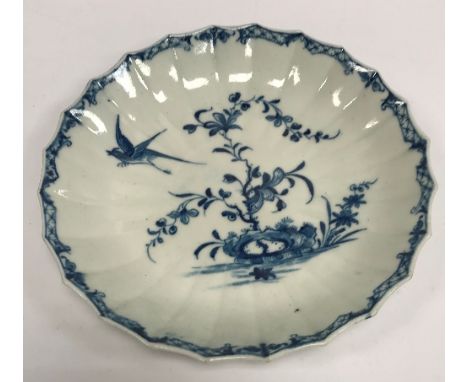 An 18th Century Worcester blue and white scallop shaped dish with bird alighting from exotic flowers, 18 cm diameter CONDITIO
