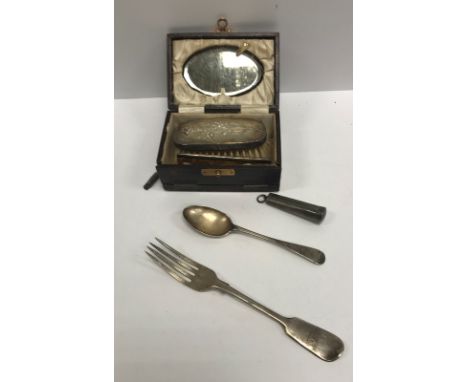 A George V travelling brush set with embossed floral spray decorated backed brush and silver mounted comb and oval mirror in 