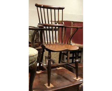 A 19th Century Thames Valley beech and elm stick back chair, the shaped top rail over a yoke back with scroll arms and saddle