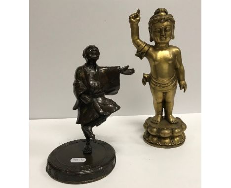 A brass Tibetan style figure of the infant Shakyamuni Buddha, his right finger pointing at the heavens, his left finger point