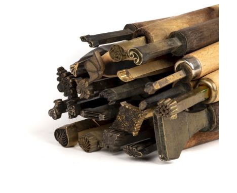 * Decorative finishing tools. 21 brass decorative finishing tools, comprising mostly centre tools of traditional design, each