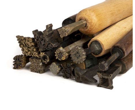 * Decorative finishing tools. 13 brass decorative finishing tools, comprising mostly centre tools of traditional design, &amp