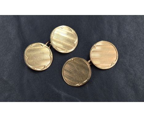 A matched pair of 9ct gold cufflinks, the panels of circular form with plain borders and central engine turned decoration, ha