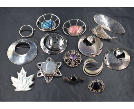 A selection of white metal brooches of various forms including filligree, Celtic knott, etc several stamped silver