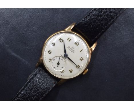 A gent's Smiths Deluxe 9ct gold manual wrist watch having Arabic numeral dial with subsidiary seconds and black hands on a si