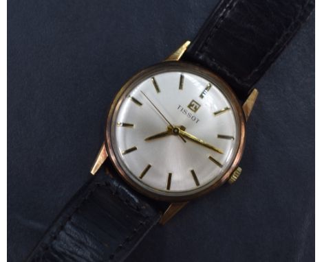 A gent's Tissot 9ct gold manual wristwatch having a baton numeral dial on silvered face in a plain gold case and black leathe