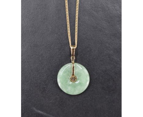 A Chinese jade disc pendant with 14ct gold mount and central Chinese character, on a 9ct gold chain, 5.6g