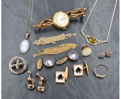 An assortment of silver and gold plated jewellery, including a gold plated wristwatch, two pairs of cufflinks, an amber Celti