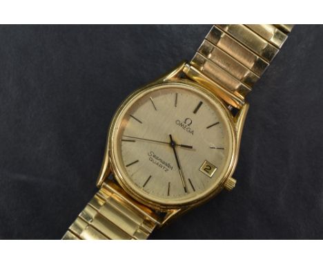 An Omega Seamaster quartz manual wind wristwatch, the gold tone dial having baton five minute markers and date aperture in go