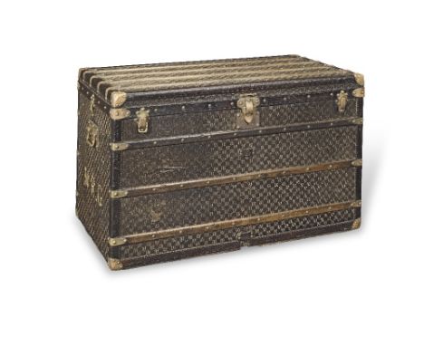 An early 20th century Louis Vuitton steamer trunkof rectangular form with brass rivets, monogramed canvas covering, slatted w