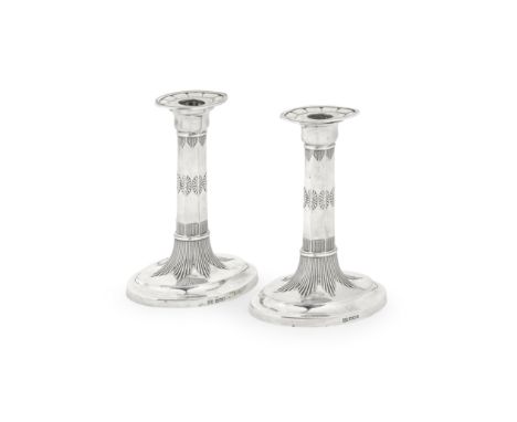 A pair of silver dwarf candlesticksHarrison Brothers & Howson, Sheffield 1916 The octagonal columns with embossed stylised fl