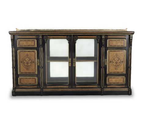 A mid Victorian 'Geometric Gothic' amboyna, ebonised, purplewood, fruitwood inlaid and parcel gilt low display cabinet by Lam