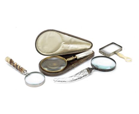 A collection of four desk magnifying glasseslate 19th and 20th centurycomprising a cased brass example with circular glass an