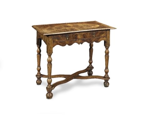 A walnut and featherbanded side tableElements dating to 1700-1720, other elements apparently of a later dateThe quarter venee