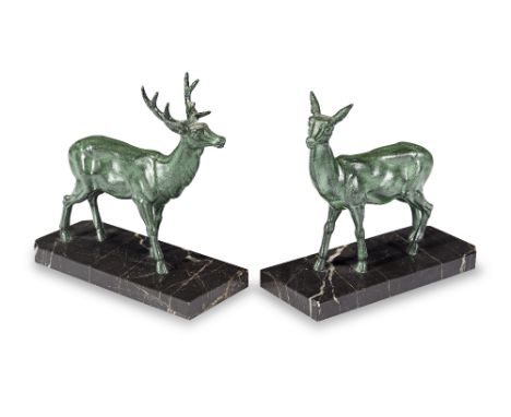 A pair of 1930's green verdigris patinated metal deer bookendsin the Art Deco stylemodelled as a stylised models of a stag an