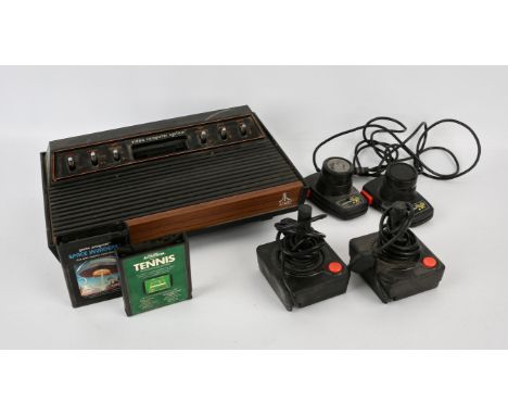 Atari 2600 console with 2 paddles, 2 classic joysticks and 2 loose games Games include: Space Invaders and Tennis All items a