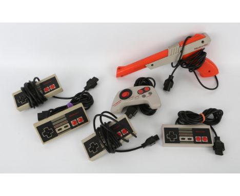 An assortment of Nintendo Entertainment System spares, peripherals and accessories Includes: Original Controller (x4) Max Con