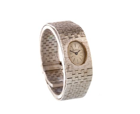 LADY'S BEUCHE GIROD NINE CARAT WHITE GOLD MANUAL WIND WRIST WATCH, the oval white dial with black baton hour markers, 17mm ca