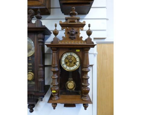 A Vienna regulator style wall clock with gilt decorated inner dial and bezel, ivory coloured chapter ring, carved and turned 