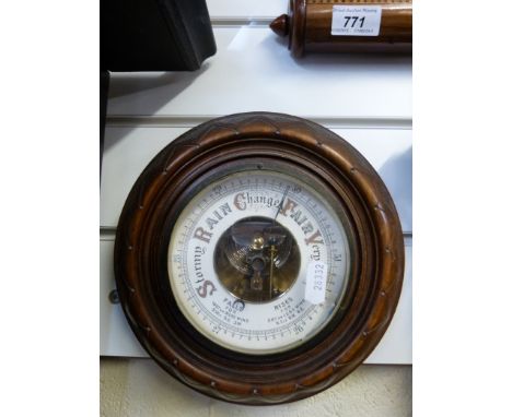 A circular mahogany aneroid wall barometer