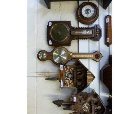 A banjo style aneroid barometer together with an oak framed oval mirror with bevelled glass