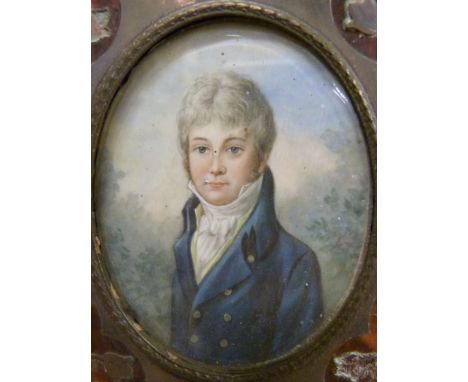 A 19thC portrait miniature on ivory of a young gentleman in period dress in tortoiseshell and brass frame