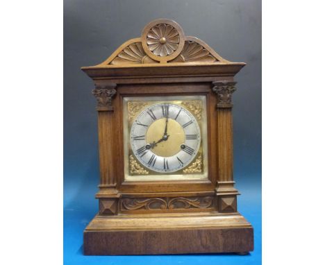 A beechwood-cased bracket style mantel clock with two-train German movement, striking on the quarters, silvered chapter ring 